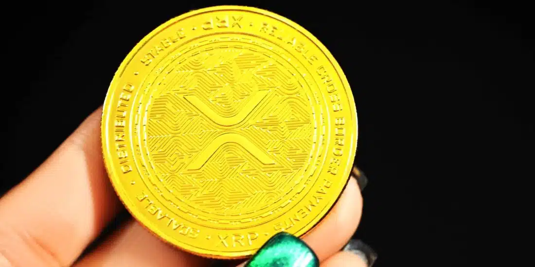 gold round coin on persons hand